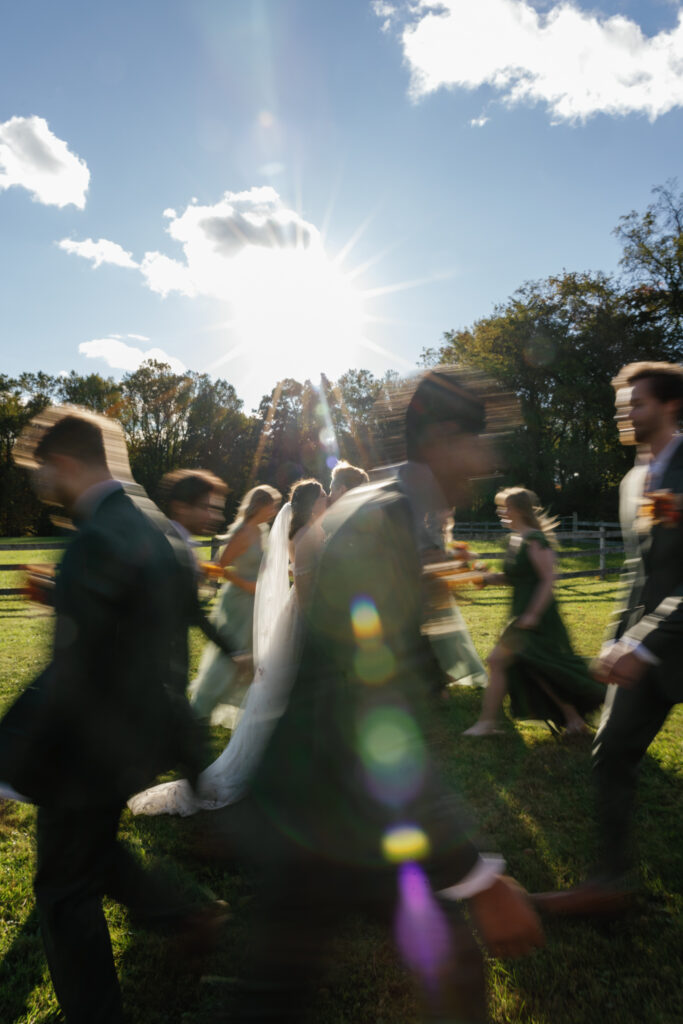 Blurry image of newlyweds kissing.