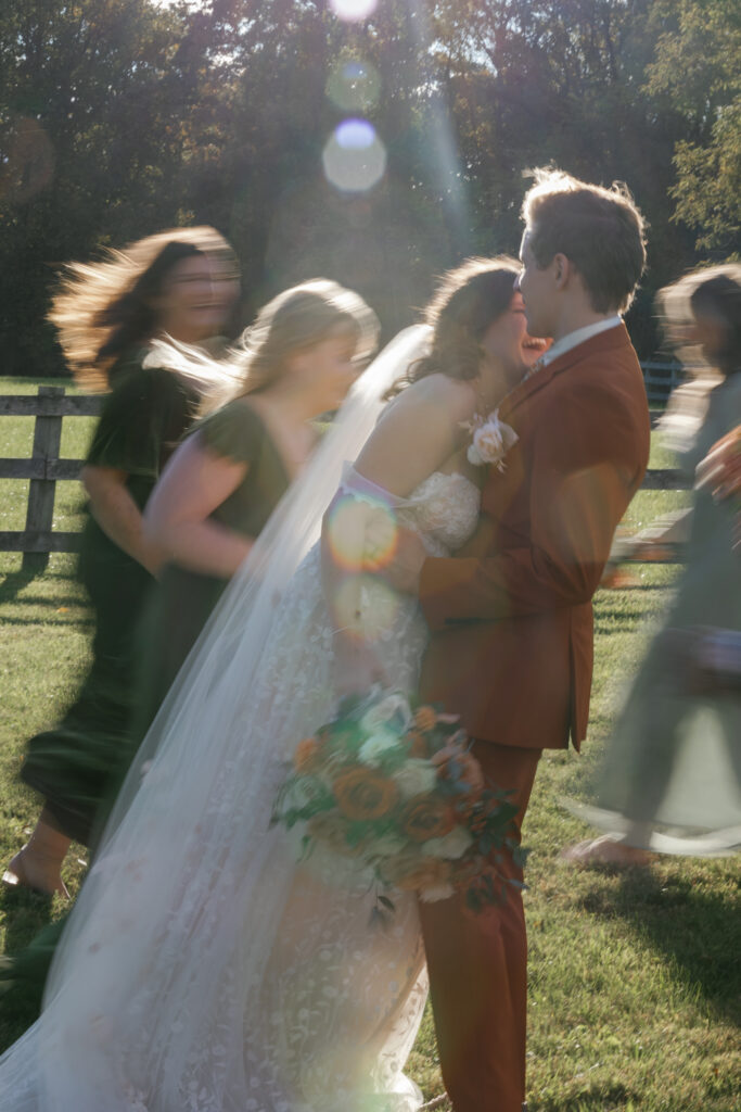 Blurry image of newlyweds kissing.